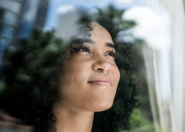 Girl looking through window